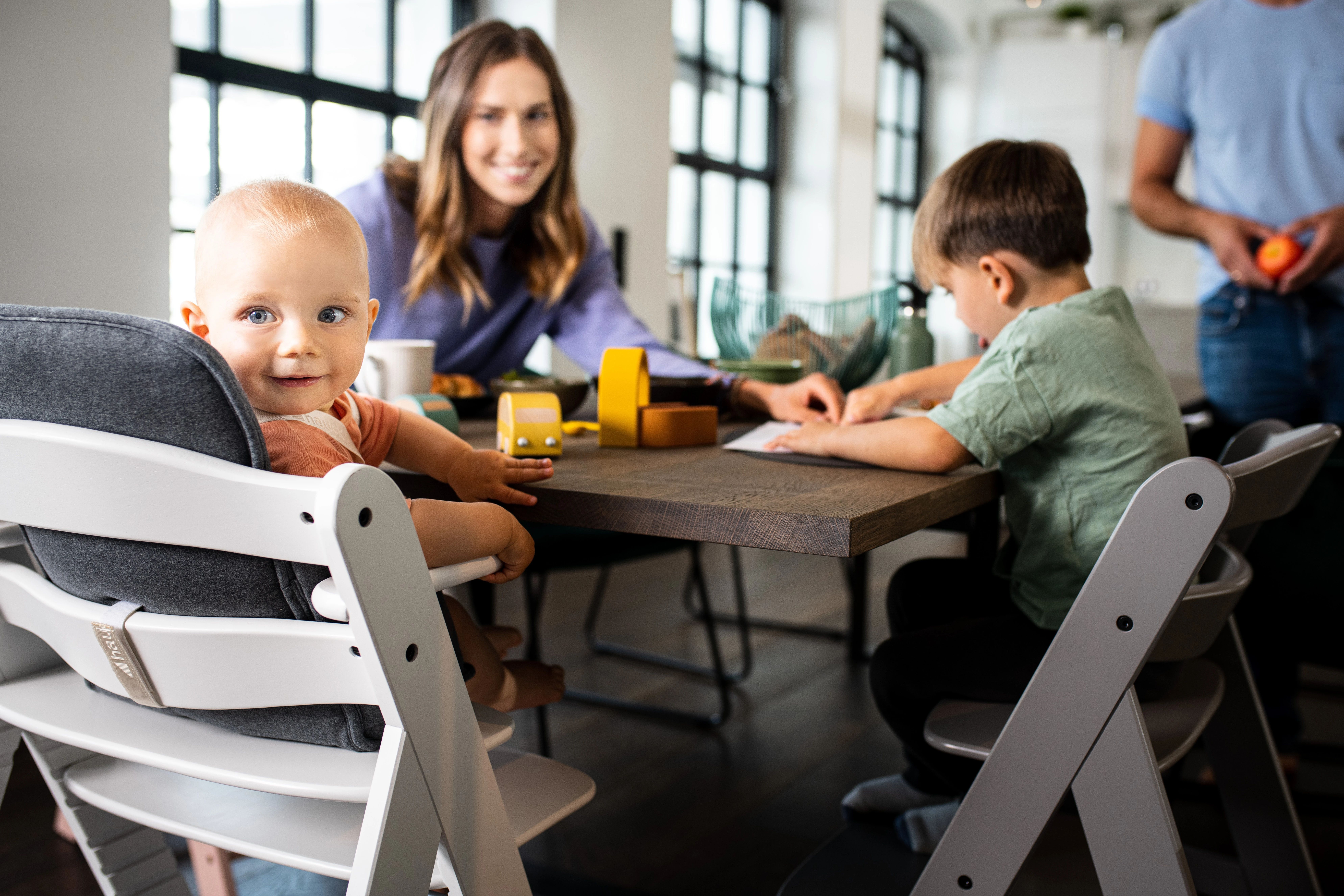 geschwister und eltern sitzen am esstisch mitwachsender hauck hochstuhl